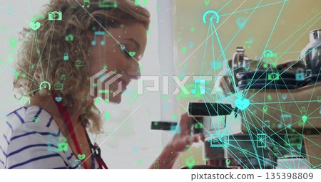 Barista adjusting portafilter under group head in cafe near window, with digital icons, copy space Barista adjusting portafilter under group head in cafe near window, with digital icons, copy space 135398809