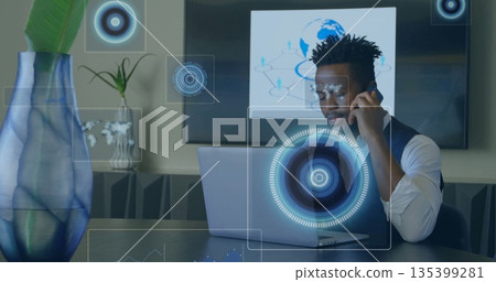 Talking executive wearing white shirt vest using smartphone, laptop at office, with tech overlays Talking executive wearing white shirt vest using smartphone, laptop at office, with tech overlays 135399281