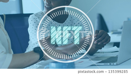 Colleagues in work attire discussing documents at office, open laptop, teal coffee mug, NFT overlay Colleagues in work attire discussing documents at office, open laptop, teal coffee mug, NFT overlay 135399285