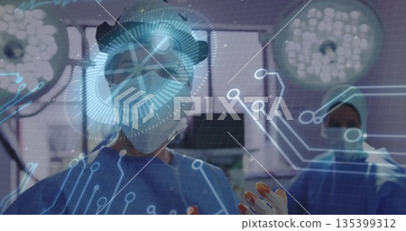 Lead surgeon in scrubs and headlight conducting surgery in operating room, with holographic overlay Lead surgeon in scrubs and headlight conducting surgery in operating room, with holographic overlay 135399312