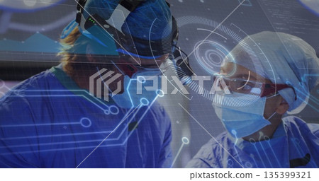 Consulting surgeons wearing scrubs, head-mounted visual devices in operating room viewing graphics Consulting surgeons wearing scrubs, head-mounted visual devices in operating room viewing graphics 135399321