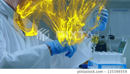 Senior scientist wearing lab coat transferring yellow liquid into tube rack at bench, with pipette Senior scientist wearing lab coat transferring yellow liquid into tube rack at bench, with pipette 135399359