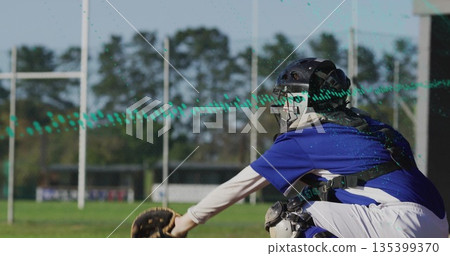 Kneeling female catcher extending mitt on grassy field, with helmet and chest protector, copy space 135399370
