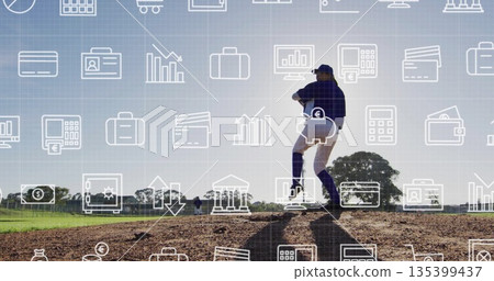 Winding up pitcher wearing uniform and glove on mound at baseball field, with financial icons 135399437