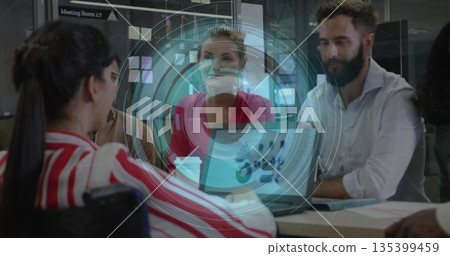 Collaborating colleagues discussing ideas in Meeting Room 1 135399459