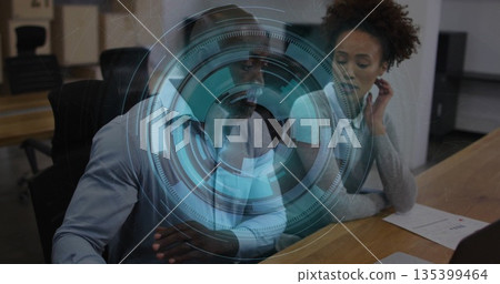 Collaborating professionals analyzing holographic interface in meeting room, with charts and laptop Collaborating professionals analyzing holographic interface in meeting room, with charts and laptop 135399464