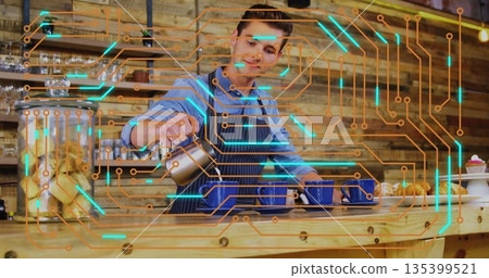 Barista wearing apron pouring coffee from metal jug into blue cups in cafe, with circuit overlay Barista wearing apron pouring coffee from metal jug into blue cups in cafe, with circuit overlay 135399521