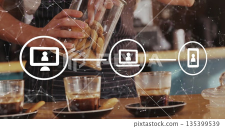 Pouring cookies barista wearing striped apron tilting glass jar at coffee counter, with tech icons 135399539