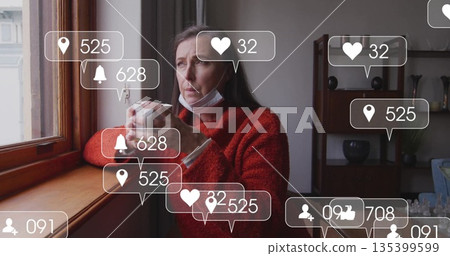 Gazing woman in red sweater, mask, holding white mug by home window, floating icons, copy space 135399599