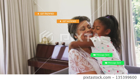 Hugging grandmother and grandchild in living room, with heart-print shirt, piano and digital labels 135399600