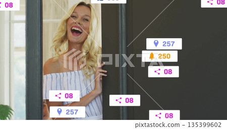 Laughing mid adult woman opening door at home entrance, with floating digital icons, copy space Laughing mid adult woman opening door at home entrance, with floating digital icons, copy space 135399602