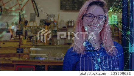 Smiling barista serving behind café counter in apron with display case, digital overlay, copy space Smiling barista serving behind café counter in apron with display case, digital overlay, copy space 135399628