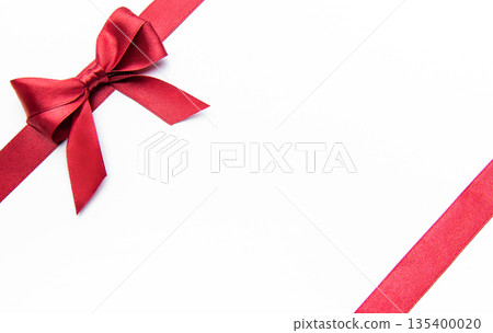 Red ribbon bow on a white background creating border 135400020