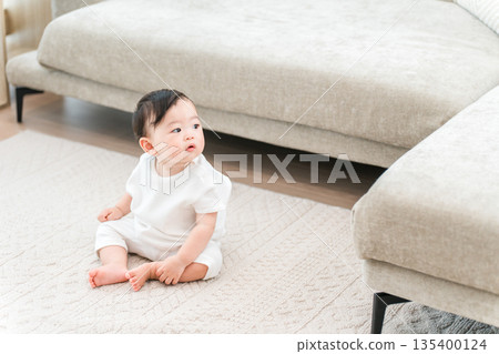 Baby sitting in the living room of his home Baby sitting in the living room of his home 135400124
