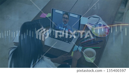 Consulting woman writing notes at desk, using laptop, sticky notes, mug, eyeglasses, overlays 135400397