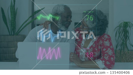 Smiling mature couple resting hand on shoulder using laptop in living room, with vital-sign overlay Smiling mature couple resting hand on shoulder using laptop in living room, with vital-sign overlay 135400406