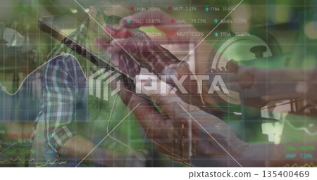 Senior craftsman wearing goggles examining rifle scope at workbench, with stock charts overlay 135400469