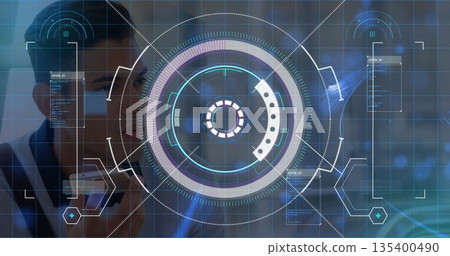 Developer holding smartphone up to face in high tech lab, with HUD and data panels Developer holding smartphone up to face in high tech lab, with HUD and data panels 135400490