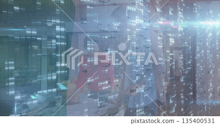 Woman in red blazer and colleague examining documents, laptop at conference table with digital grid 135400531