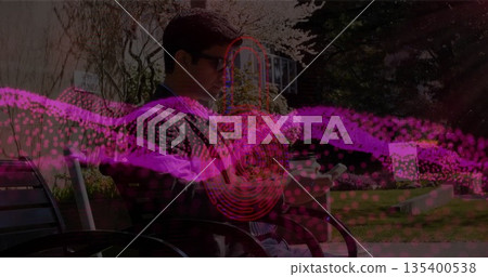 Blazer-clad man sitting on metal bench on park lawn checking smartphone, with digital wave Blazer-clad man sitting on metal bench on park lawn checking smartphone, with digital wave 135400538
