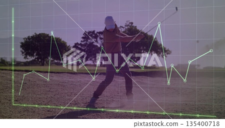 Swinging golfer hitting ball from sand bunker on golf course, with translucent green chart overlay 135400718
