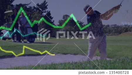 Swinging golfer sending sand spraying from bunker on fairway, with golf cart companions, copy space 135400728