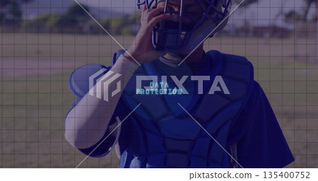 Male athlete in catcher's helmet adjusting mask on baseball field, with DATA PROTECTION chest guard Male athlete in catcher's helmet adjusting mask on baseball field, with DATA PROTECTION chest guard 135400752