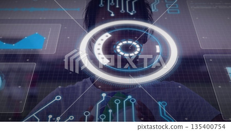 Standing woman interacting with holographic AR interface in dark studio, with grid, HUD and charts Standing woman interacting with holographic AR interface in dark studio, with grid, HUD and charts 135400754