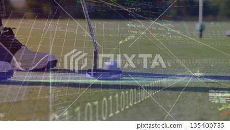 Aligning golf putter head over ball at putting green, with spiked shoe and digital data overlays 135400785