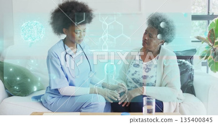 Nurse in blue scrubs holding hand, discussing health in living room with stethoscope and holograms 135400845