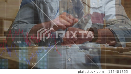 Carving craftsman in denim shirt using chisels and mallet in home workshop with finance graphs Carving craftsman in denim shirt using chisels and mallet in home workshop with finance graphs 135401863