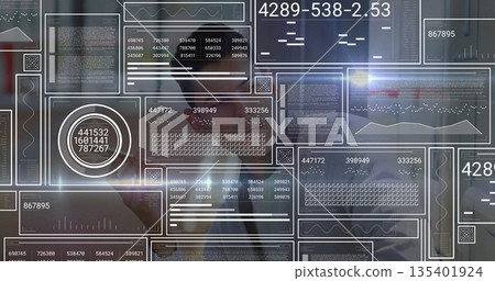 Interacting Hispanic man in suit adjusting floating digital panels at office, numeric dashboards 135401924