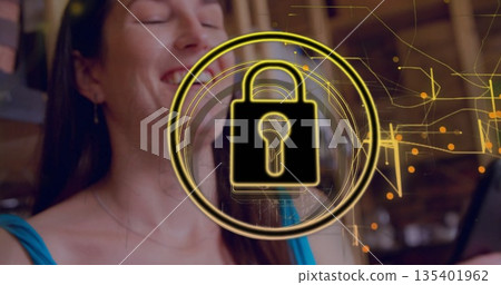 Woman wearing turquoise tank sipping drink at café with laptop and glowing padlock circuit overlay Woman wearing turquoise tank sipping drink at café with laptop and glowing padlock circuit overlay 135401962