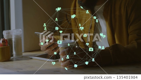 Holding coffee cup and checking smartphone, man in mustard jacket at cafe with tablet, health icons 135401984