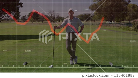 Standing golfer gripping driver club and analyzing digital graph over ball on golf teeing ground 135401992