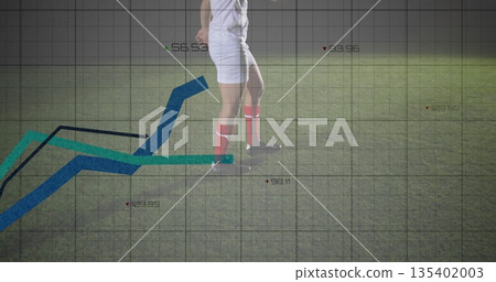 Showing soccer player's legs wearing white kit, red socks running on grass pitch with grid overlay 135402003