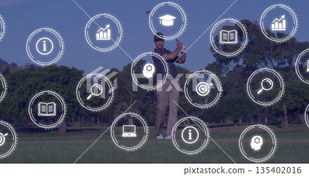 Swinging man wearing polo shirt cap hitting golf shot with club on fairway, with data icons 135402016