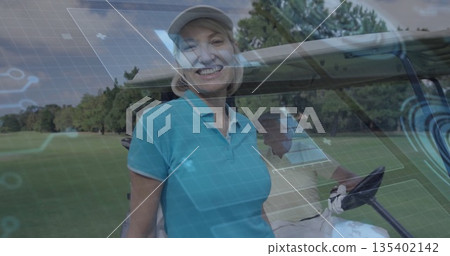 Standing smiling female golfer holding golf glove beside cart on sunlit fairway, with golf clubs Standing smiling female golfer holding golf glove beside cart on sunlit fairway, with golf clubs 135402142