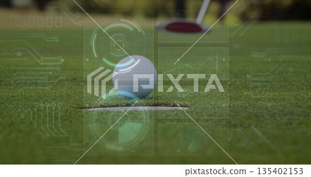 Resting golf ball on hole edge of trimmed putting green with holographic UI graphics, putter head Resting golf ball on hole edge of trimmed putting green with holographic UI graphics, putter head 135402153