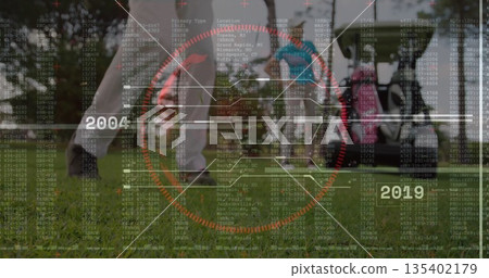 Swinging female golfer wearing trousers and golf shoes on fairway, with red reticle and code charts Swinging female golfer wearing trousers and golf shoes on fairway, with red reticle and code charts 135402179