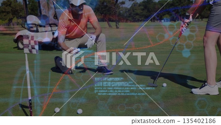 Kneeling instructor aligning putt on putting green, woman holding putter, with holographic data 135402186