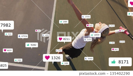 Serving tennis player wearing white headband holding racket on hard court lines with reaction icons 135402290