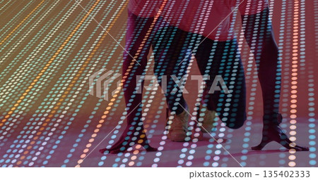 Dancers' legs stepping on stage, with red dress, black stiletto heels, tan lace-up shoes, LED grid Dancers' legs stepping on stage, with red dress, black stiletto heels, tan lace-up shoes, LED grid 135402333