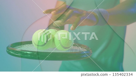 Holding racket balancing three balls, player wearing sleeveless shirt, wristband in pastel studio 135402334