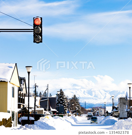 View of the Tokachi mountain range from the main street of Biei, Hokkaido in midwinter View of the Tokachi mountain range from the main street of Biei, Hokkaido in midwinter 135402378
