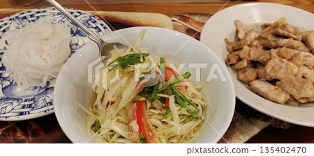 Spicy som tam served with sticky rice and fried pork 135402470