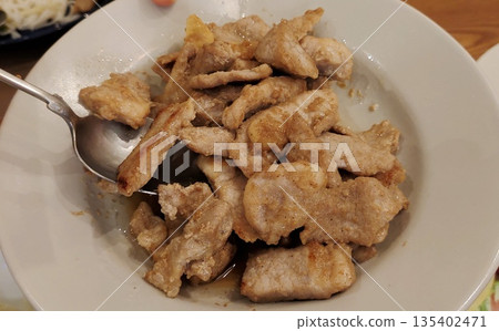 Crispy fried pork pieces served hot and flavorful 135402471