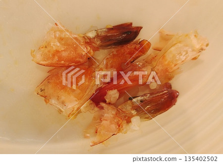 Leftover shrimp shells and scraps after eating Leftover shrimp shells and scraps after eating 135402502
