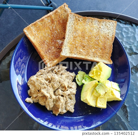 Avocado and scrambled eggs on toasted bread Avocado and scrambled eggs on toasted bread 135402512