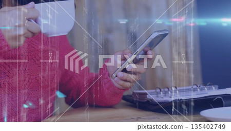 Holding mug, woman in red sweater scrolling smartphone at wooden table, with notebook, copy space Holding mug, woman in red sweater scrolling smartphone at wooden table, with notebook, copy space 135402749